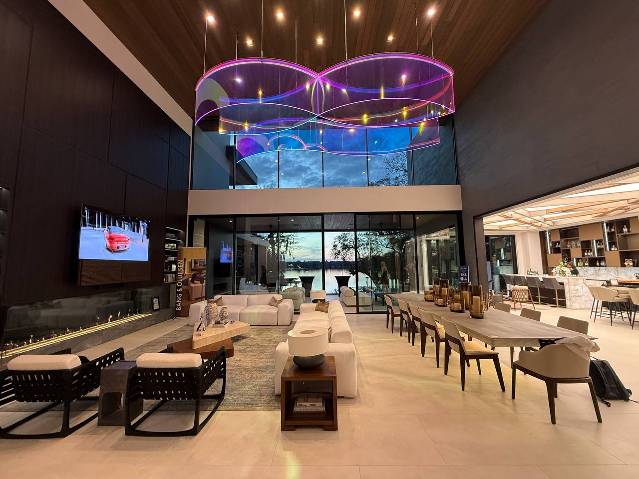Living room at dusk with fireplace and lake view