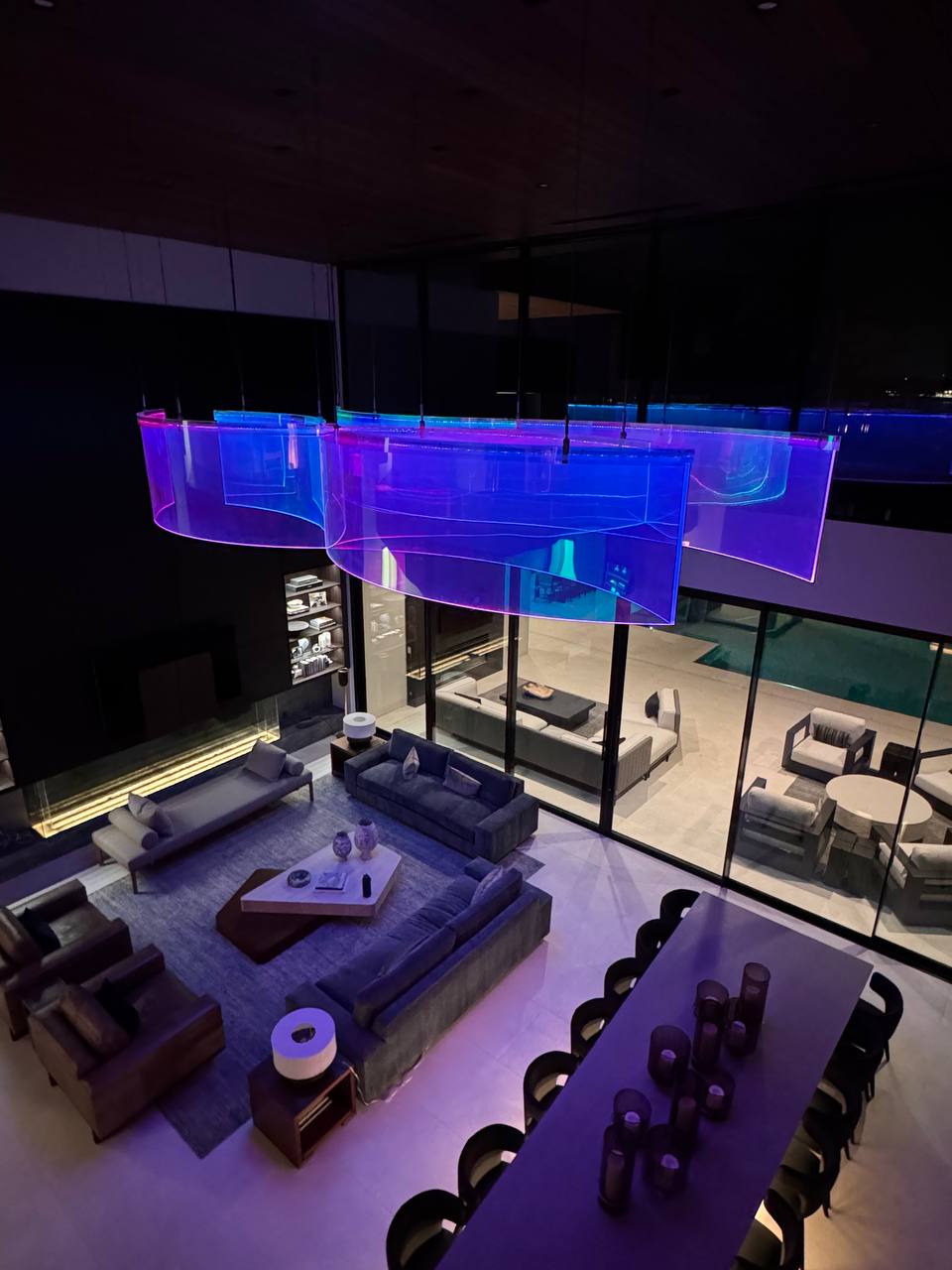 Overhead view from mezzanine โ Spectral Wake sculpture glowing blue and purple