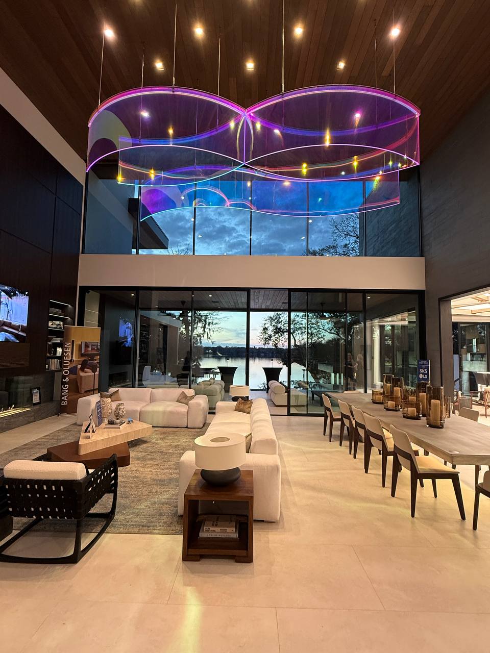 Spectral Wake sculpture at twilight with lake view