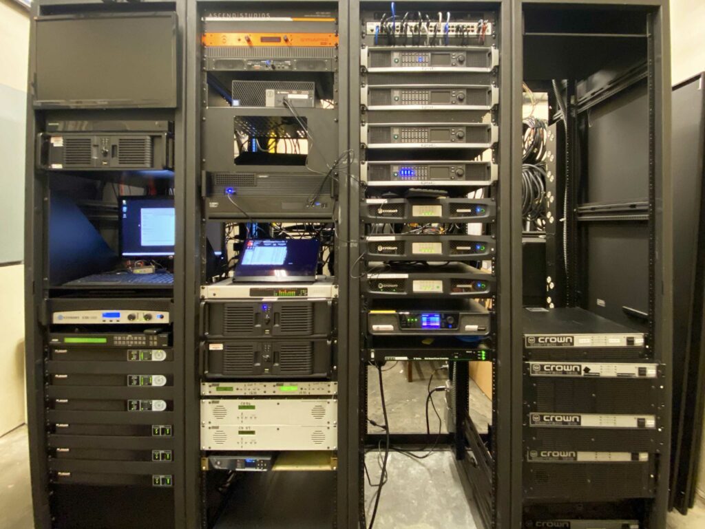 AV equipment racks — Crown amps, Q-SYS, media players